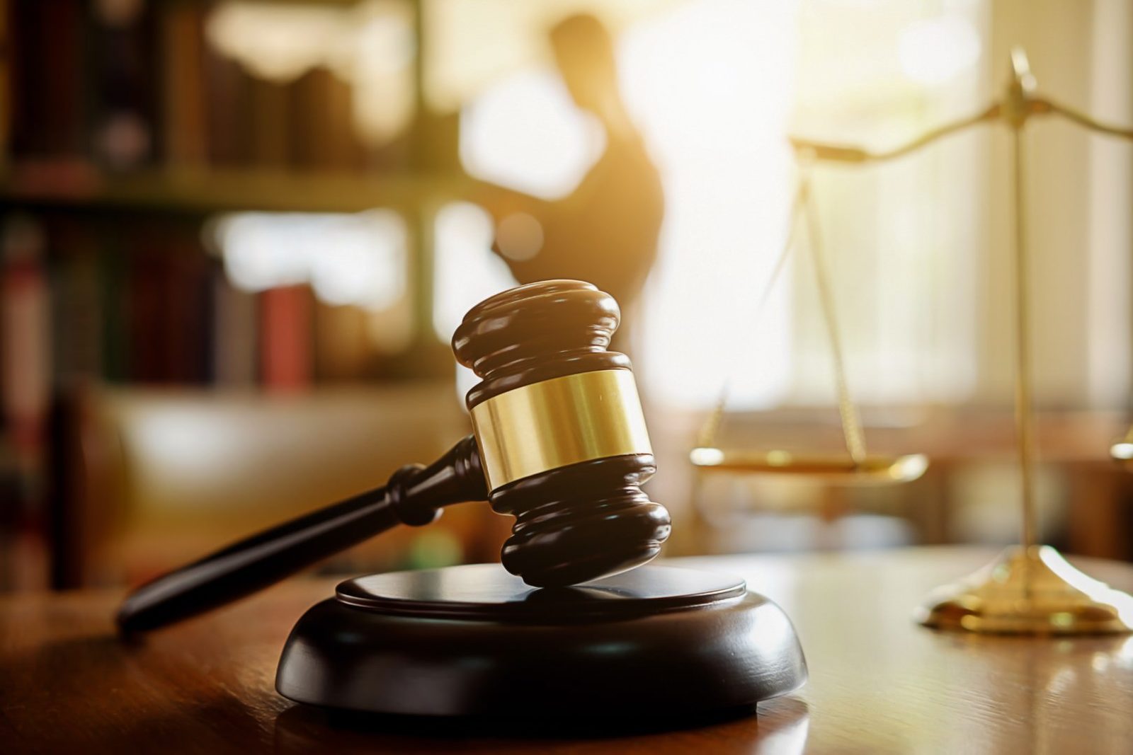 Judge gavel and scales of justice in a law library